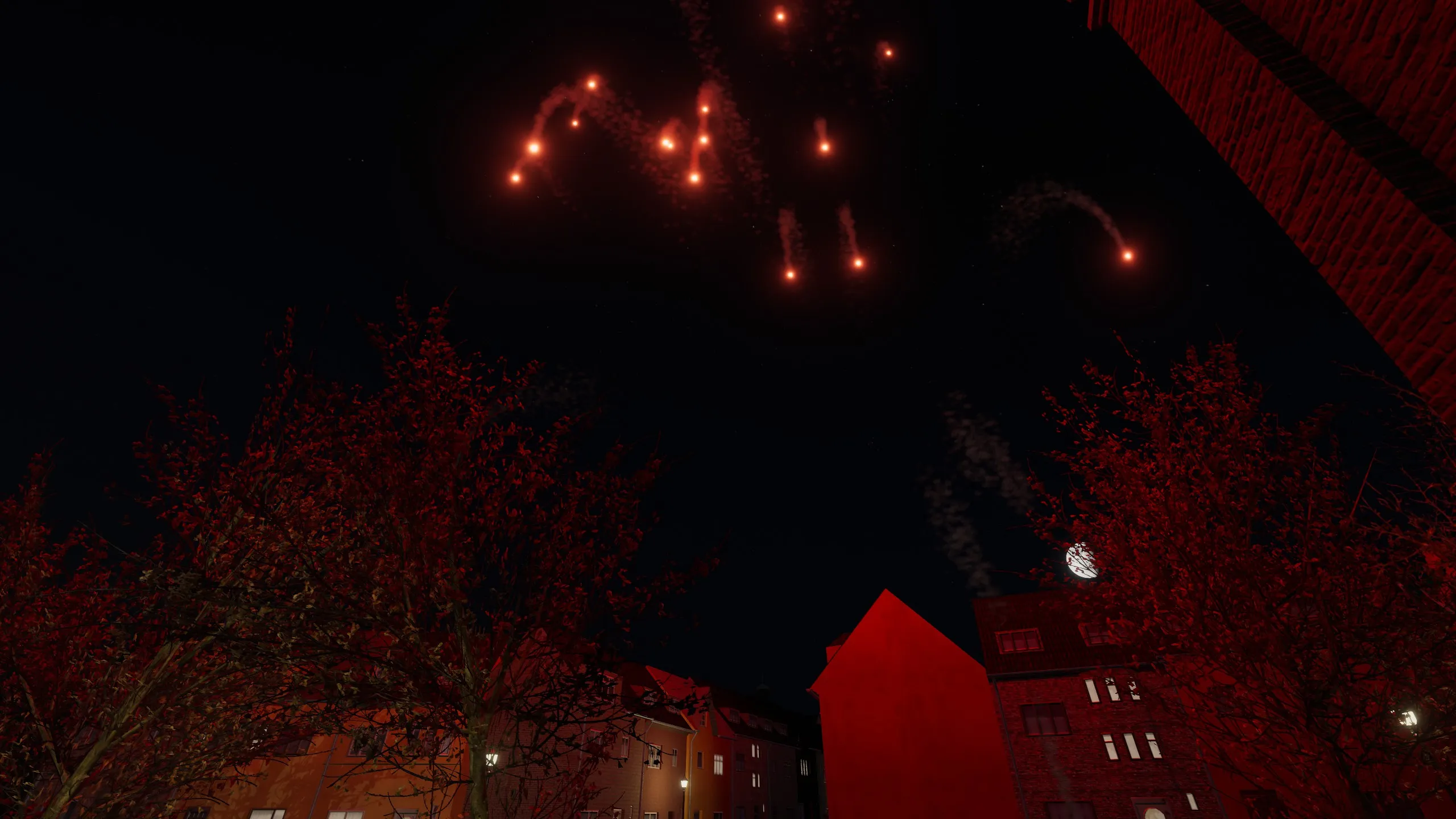 Deep red shells bursting high above rooftops and autumn trees, with smoke trails curling against a black sky.